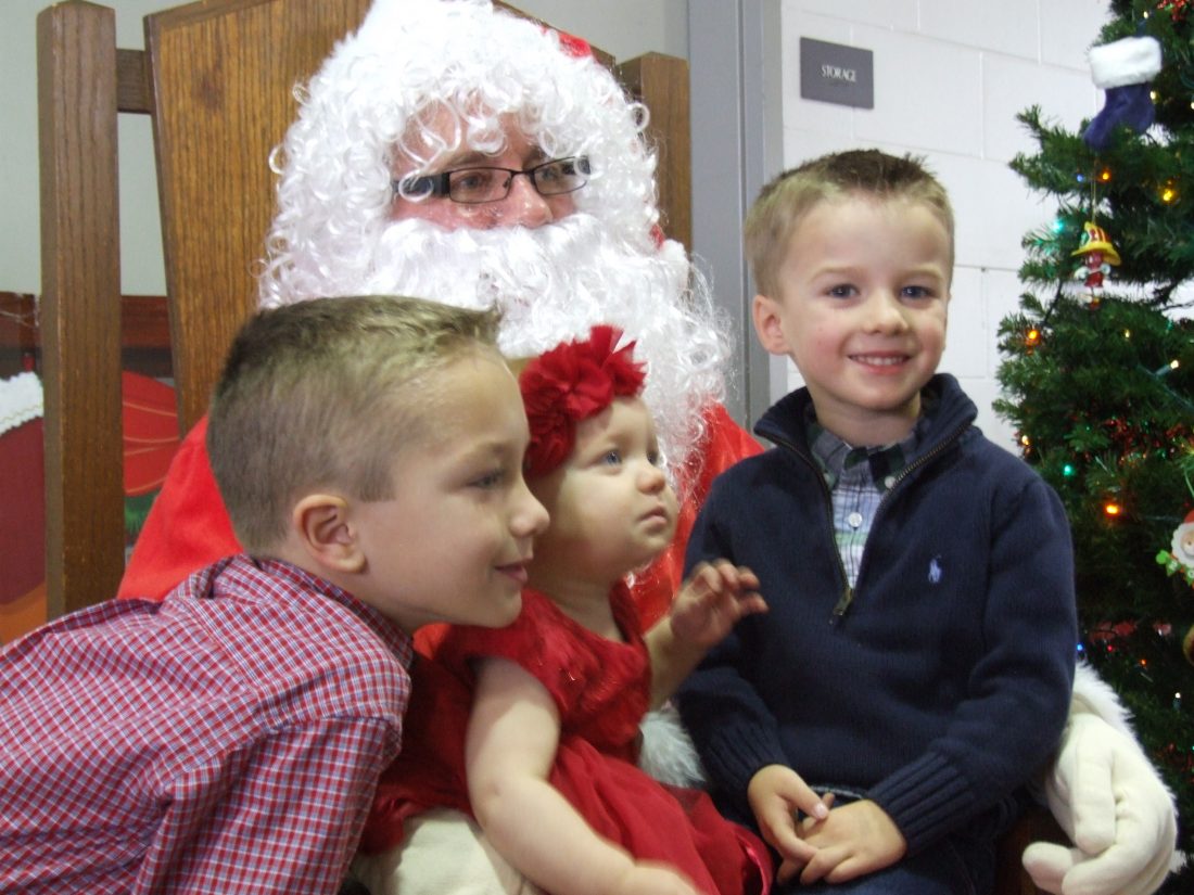 Two children on Santa's lap at a previous Breakfast with Santa event